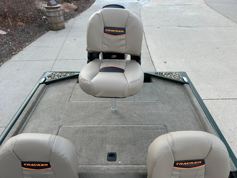 Slide: The Image of 2025 Tracker Bass Tracker Classic Limited boat seats on deck, featuring beige upholstery. - 6