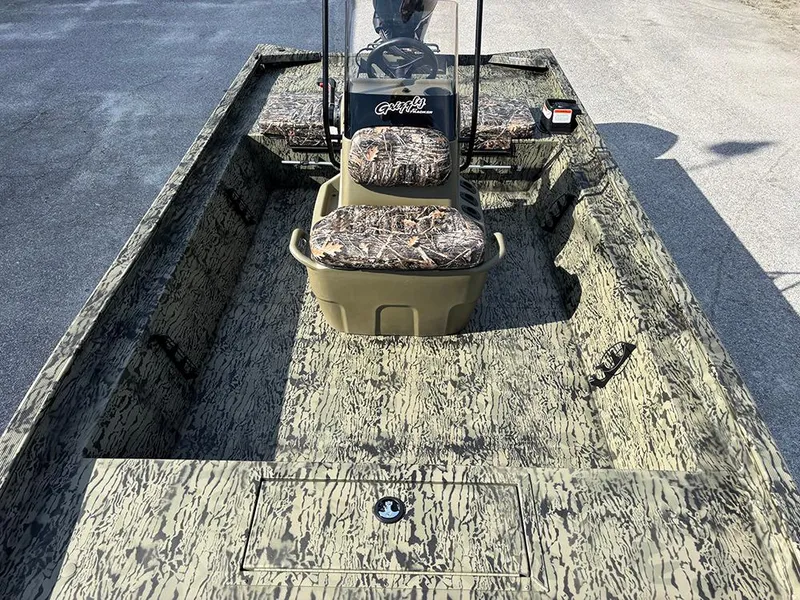 Slide: The Image of 2025 Tracker Grizzly 1860 CC boat with camouflage seating and flooring. - 10
