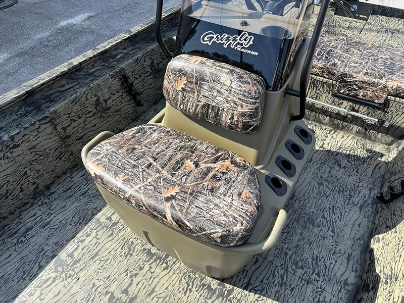 Slide: The Image of 2025 Tracker Grizzly 1860 CC boat with camo seats and console. - 13