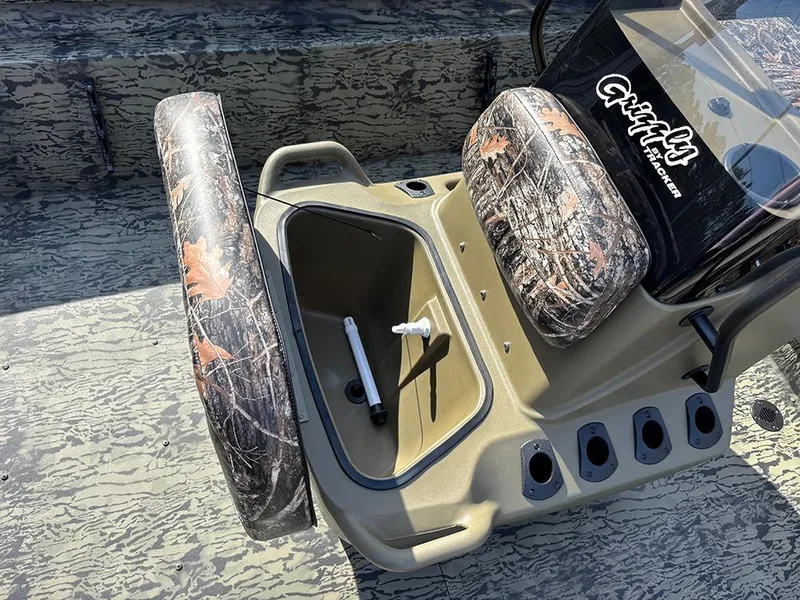 Slide: The Image of 2025 Tracker Grizzly 1860 CC boat interior with camo seats and storage compartment. - 14