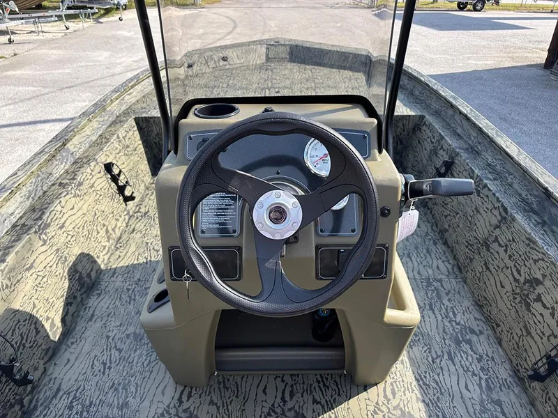 Slide: The Image of 2025 Tracker Grizzly 1860 CC boat console with steering wheel and gauges. - 17