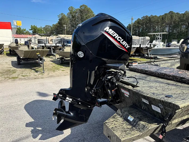 Slide: The Image of 2025 Tracker Grizzly 1860 CC boat with Mercury outboard motor in a dealership lot. - 18