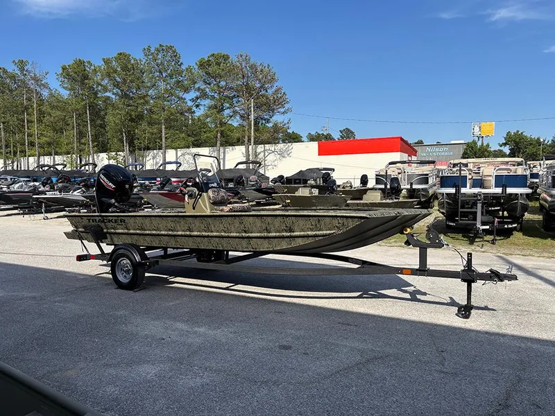 Slide: The Image of 2025 Tracker Grizzly 1860 CC boat on trailer in outdoor dealership lot. - 4