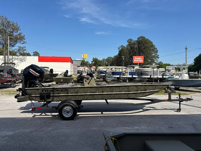 Slide: The Image of 2025 Tracker Grizzly 1860 CC boat on trailer in outdoor storage area. - 5