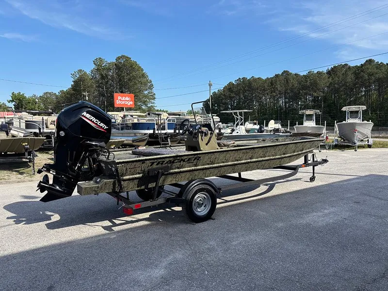 Slide: The Image of 2025 Tracker Grizzly 1860 CC boat on trailer, parked outdoors, with Mercury outboard motor. - 6