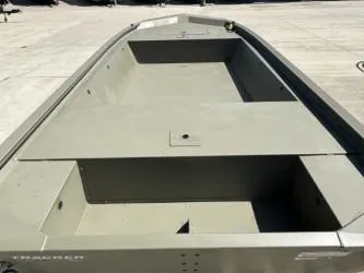 Slide: The Image of 2025 Tracker Grizzly 1648 Jon boat, spacious interior, parked on concrete surface. - 3