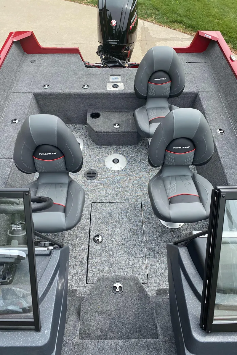 Slide: The Image of 2025 Tracker Pro Guide V-175 WT boat interior with two gray seats and carpeted flooring. - 4
