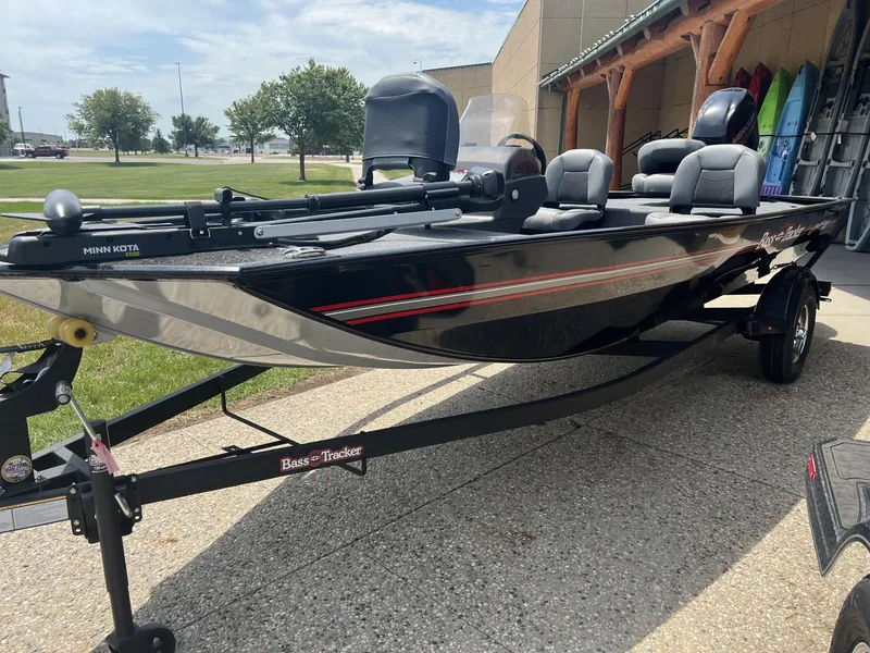 The Image of 2025 Tracker Bass Tracker Classic XL boat on trailer, parked outdoors. - 0