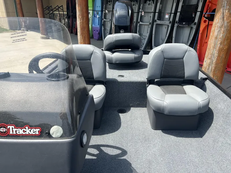 Slide: The Image of 2025 Tracker Bass Tracker Classic XL boat interior with gray seating and steering console. - 5