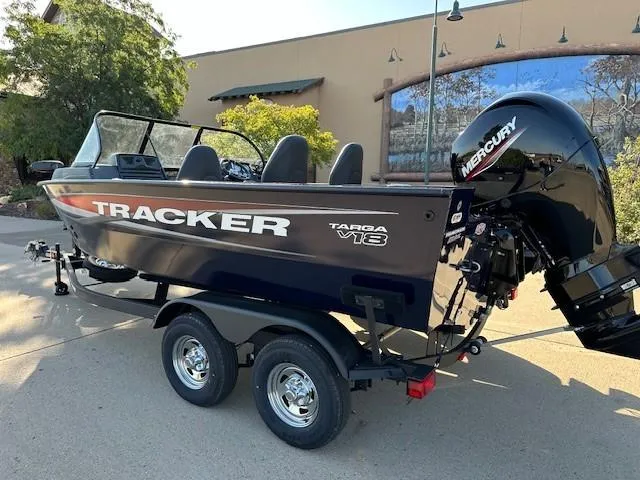 Slide: The Image of 2025 Tracker Targa V-18 Combo boat with Mercury engine on a trailer. - 2