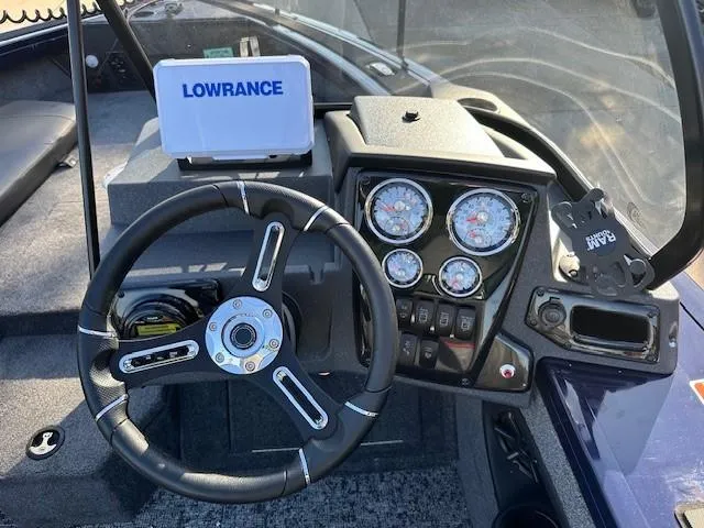 Slide: The Image of 2025 Tracker Targa V-18 Combo dashboard with steering wheel and Lowrance display. - 6