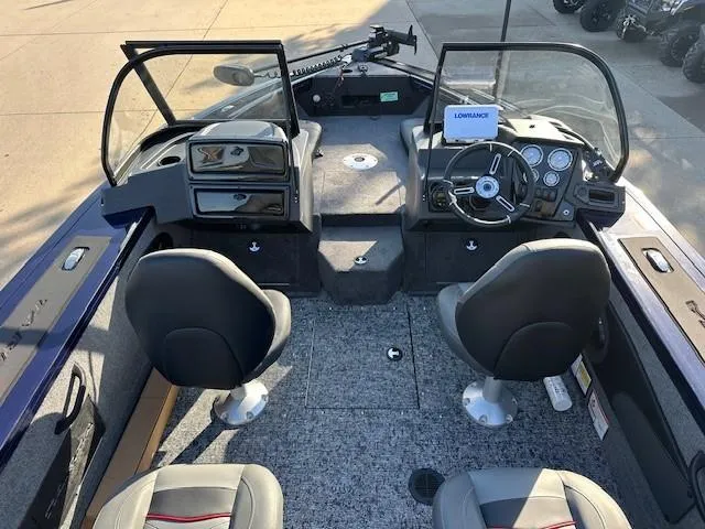 Slide: The Image of 2025 Tracker Targa V-18 Combo boat interior with dual seats and control panel. - 7