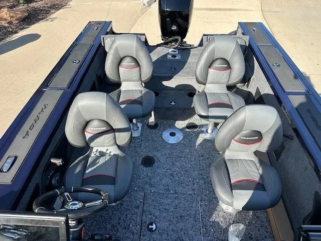 Slide: The Image of 2025 Tracker Targa V-18 Combo boat interior with four gray seats and steering console. - 8