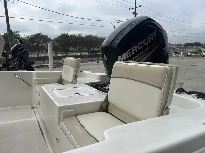 Slide: The Image of 2018 NauticStar 1810 Bay boat interior with Mercury engine, featuring cushioned seating. - 12