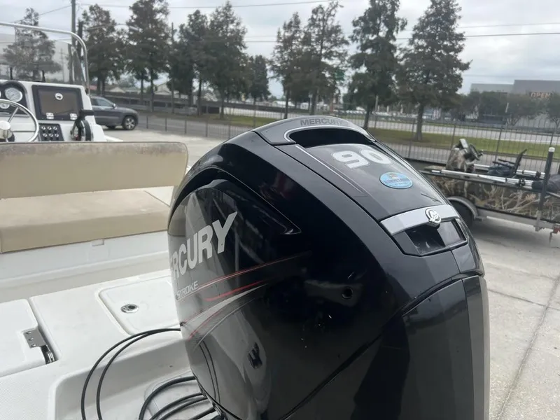 Slide: The Image of 2018 NauticStar 1810 Bay with Mercury 90 outboard engine, parked outdoors. - 14