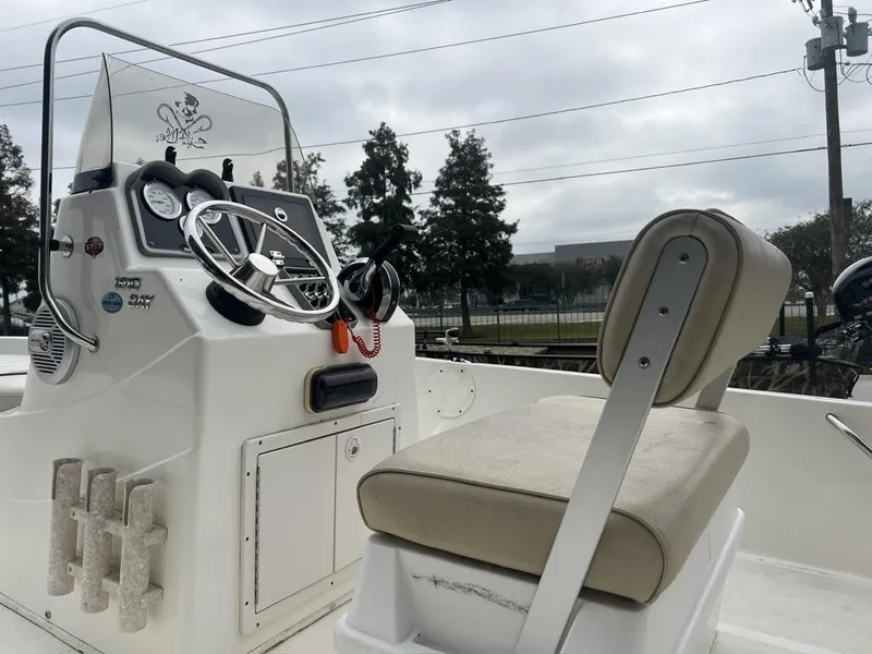 Slide: The Image of 2018 NauticStar 1810 Bay boat console and seating, featuring steering wheel and gauges. - 2