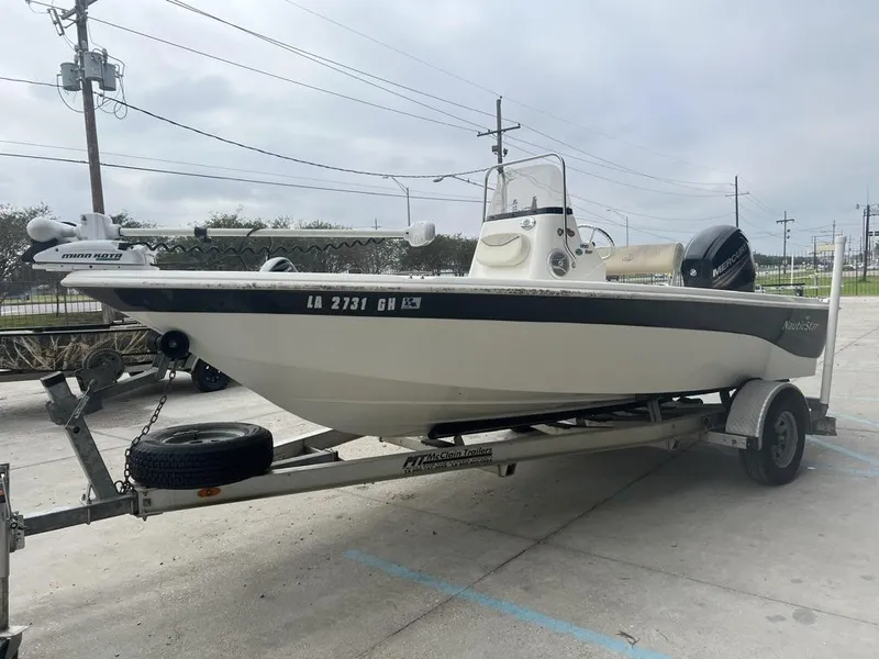 Slide: The Image of 2018 NauticStar 1810 Bay boat on trailer, parked outdoors. - 8