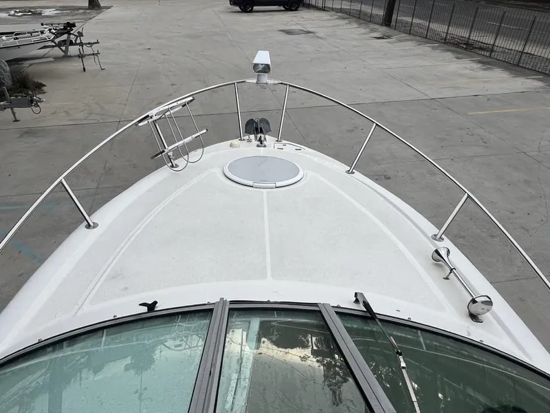 Slide: The Image of 2004 Four Winns 248 Vista boat bow view in a parking area. - 13