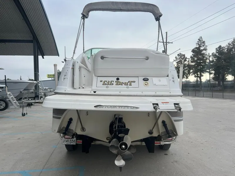 Slide: The Image of 2004 Four Winns 248 Vista boat, rear view, parked outdoors. - 4