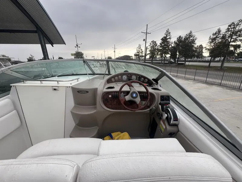 Slide: The Image of 2004 Four Winns 248 Vista boat cockpit with steering wheel and dashboard controls. - 8