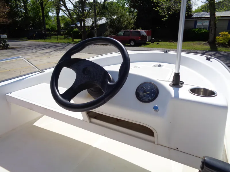 Slide: The Image of 2000 Boston Whaler 13 Sport boat dashboard with steering wheel and gauge. - 10