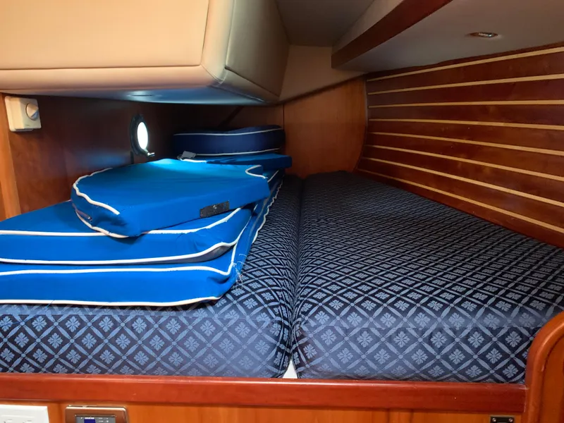 Slide: The Image of Cabin interior of 2004 ShearWater 45 yacht with blue patterned bedding. - 10