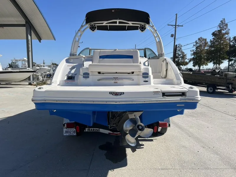 Slide: The Image of 2018 Chaparral 244 Sunesta Xtreme boat, rear view, in a marina setting. - 4