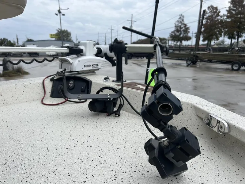 Slide: The Image of 2023 Xpress H20 BAY boat with Minn Kota trolling motor on a speckled deck. - 17