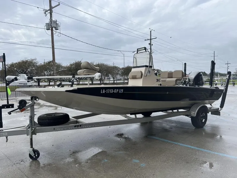Slide: The Image of 2023 Xpress H20 BAY boat on trailer in parking lot, overcast sky. - 5