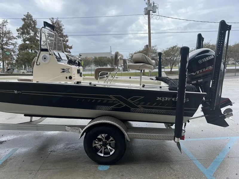 Slide: The Image of 2023 Xpress H20 BAY boat with Yamaha engine on trailer, parked outdoors. - 6