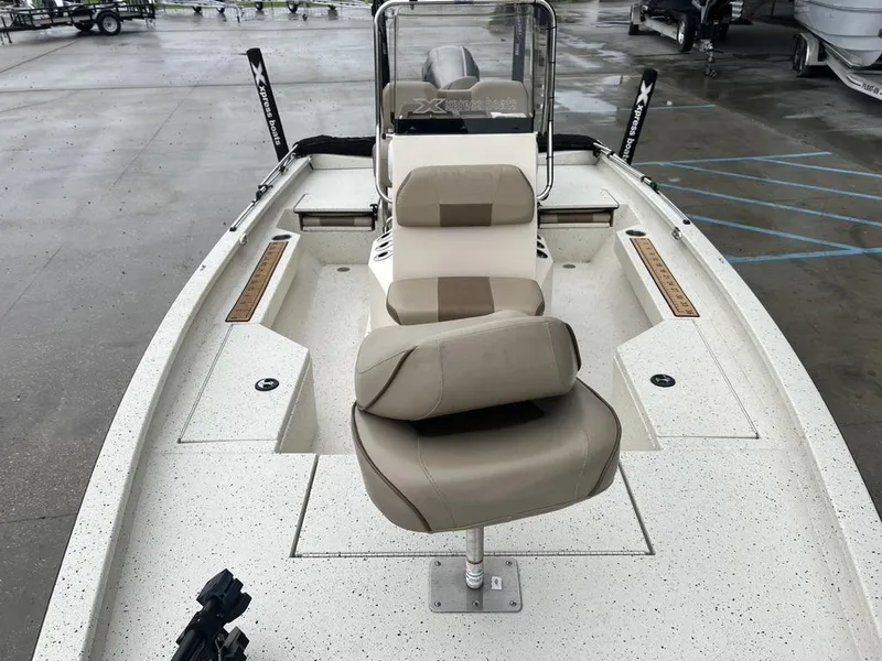 Slide: The Image of 2023 Xpress H20 BAY boat interior with beige seating and spacious deck. - 9