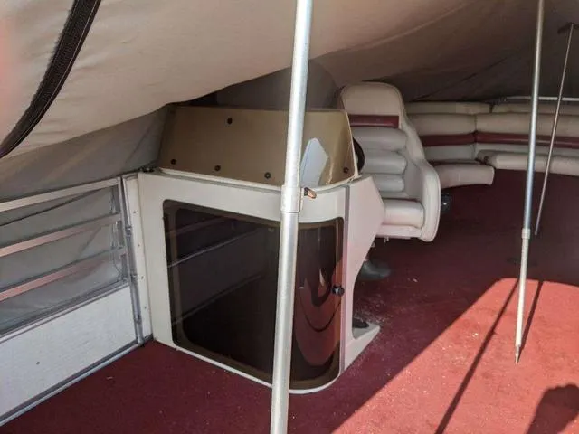 Slide: The Image of 1992 Harris 280 Heritage boat interior with red carpet and white seating. - 2