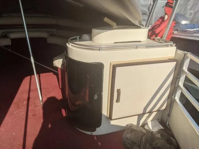 Slide: The Image of 1992 Harris 280 Heritage boat interior with storage cabinet and red carpet. - 8