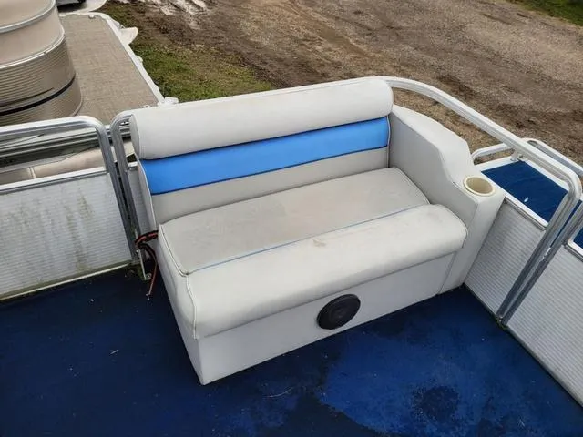 Slide: The Image of 1992 Harris Sunliner boat seat with blue and white upholstery, cup holder, and speaker. - 3