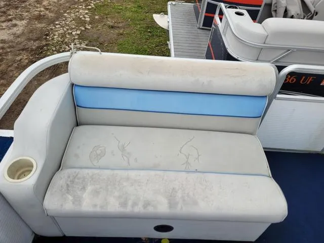Slide: The Image of 1992 Harris Sunliner boat seat with blue and white upholstery, showing signs of wear. - 4