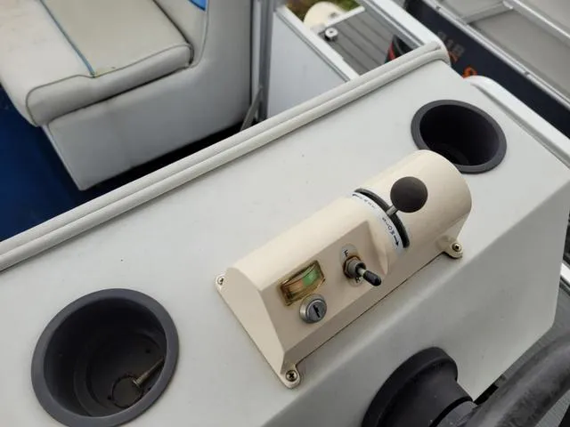 Slide: The Image of Control panel on a 1992 Harris Sunliner boat with cup holders and seating. - 5
