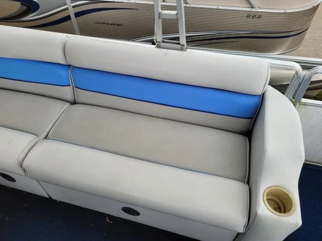 Slide: The Image of 1992 Harris Sunliner boat seat with blue and gray upholstery, featuring a built-in cup holder. - 6
