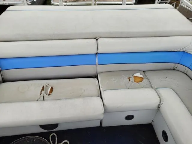 Slide: The Image of 1992 Harris Sunliner boat seats with visible wear and tears, featuring blue and white upholstery. - 7