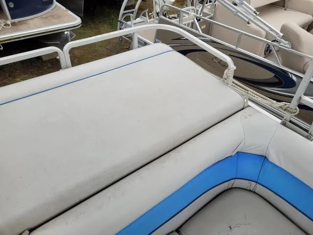 Slide: The Image of 1992 Harris Sunliner boat interior with white and blue cushioned seating. - 9