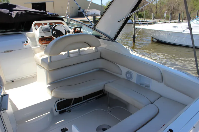 Slide: The Image of 2005 Larson Cabrio 310 boat interior with plush seating and modern dashboard. - 11