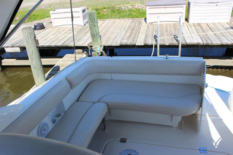 Slide: The Image of 2005 Larson Cabrio 310 boat with white leather seating at a dock. - 16