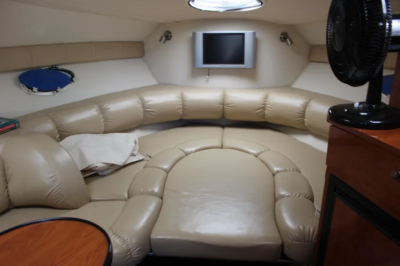 Slide: The Image of 2005 Larson Cabrio 310 interior with beige leather seating and wall-mounted TV. - 29