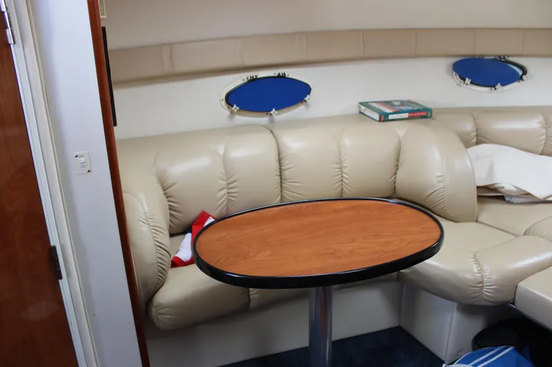 Slide: The Image of 2005 Larson Cabrio 310 interior with beige leather seating and oval table. - 31