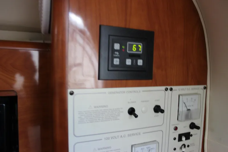 Slide: The Image of Control panel of a 2005 Larson Cabrio 310 boat, featuring digital and analog displays. - 33