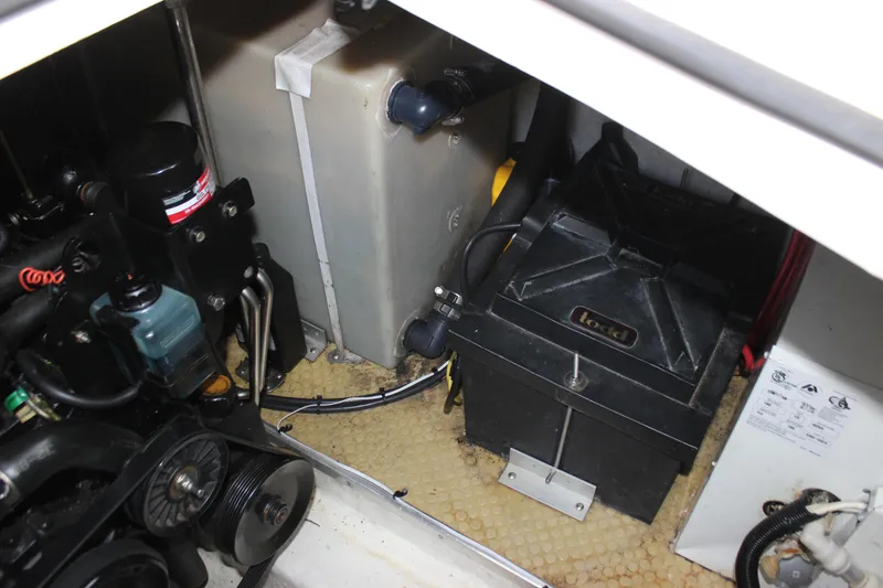 Slide: The Image of Engine compartment of a 2005 Larson Cabrio 310 boat, showing battery and components. - 35