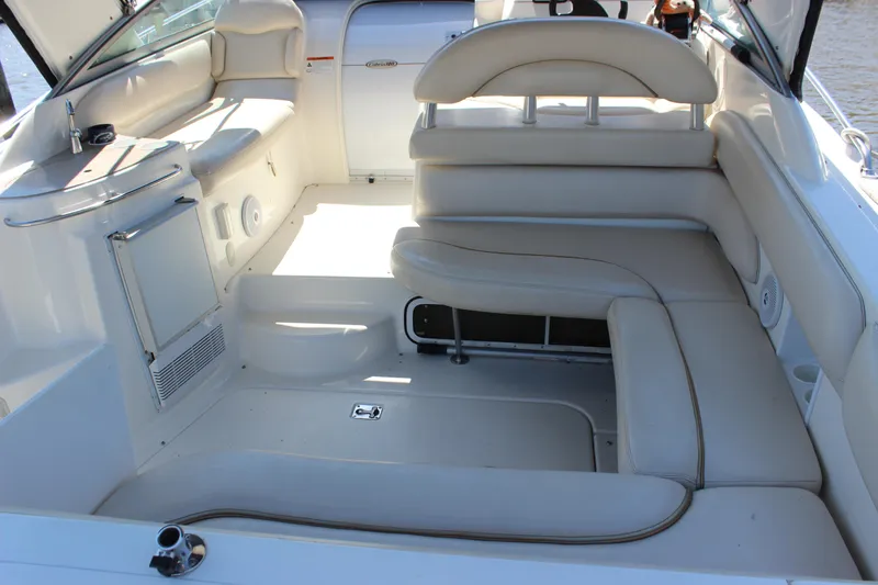 Slide: The Image of 2005 Larson Cabrio 310 boat interior with white leather seating and sleek design. - 8