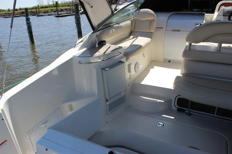 Slide: The Image of 2005 Larson Cabrio 310 boat interior with seating and water view. - 9