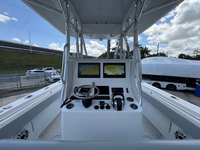 Slide: The Image of Center console of a 2021 Contender 32ST boat with navigation screens and controls. - 16