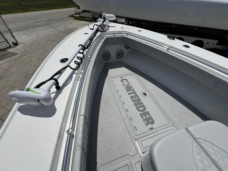 Slide: The Image of 2021 Contender 32ST boat deck with trolling motor and branded flooring. - 22