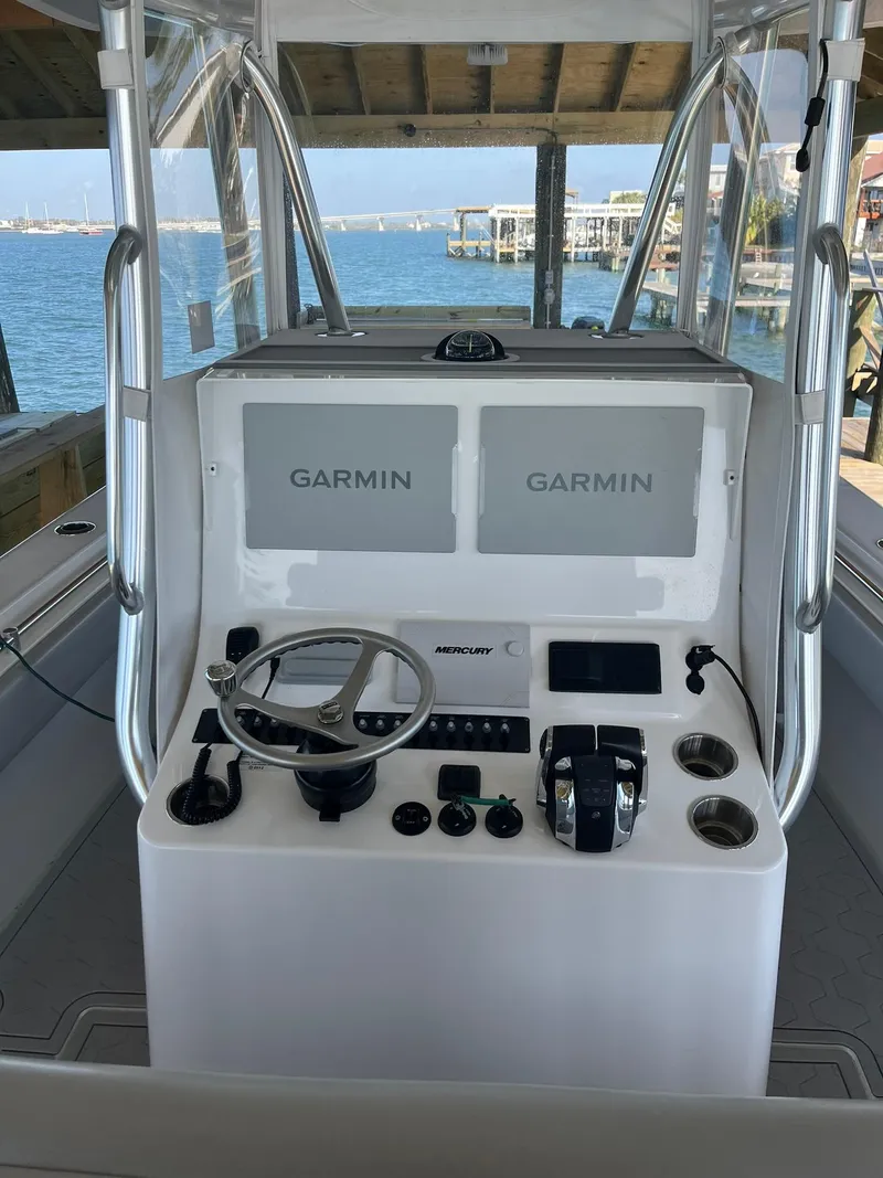 Slide: The Image of 2021 Contender 32ST boat console with dual Garmin displays and Mercury controls. - 3
